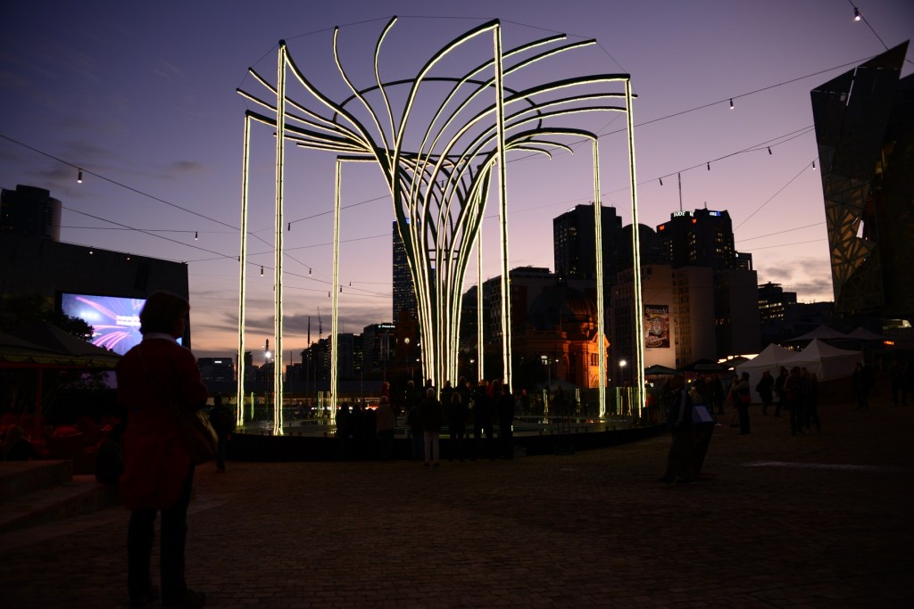 The Helix Tree in Federation Square lights up at dusk